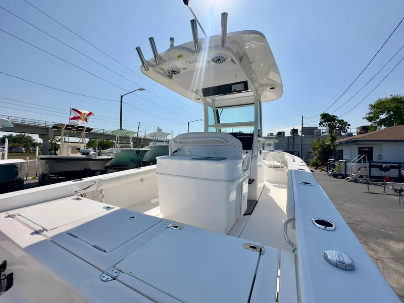 Slide: The Image of 2023 Everglades 273 Center Console boat, docked, showcasing spacious deck and modern design. - 10