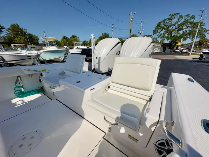 Slide: The Image of 2023 Everglades 273 Center Console boat with dual engines and seating area. - 14