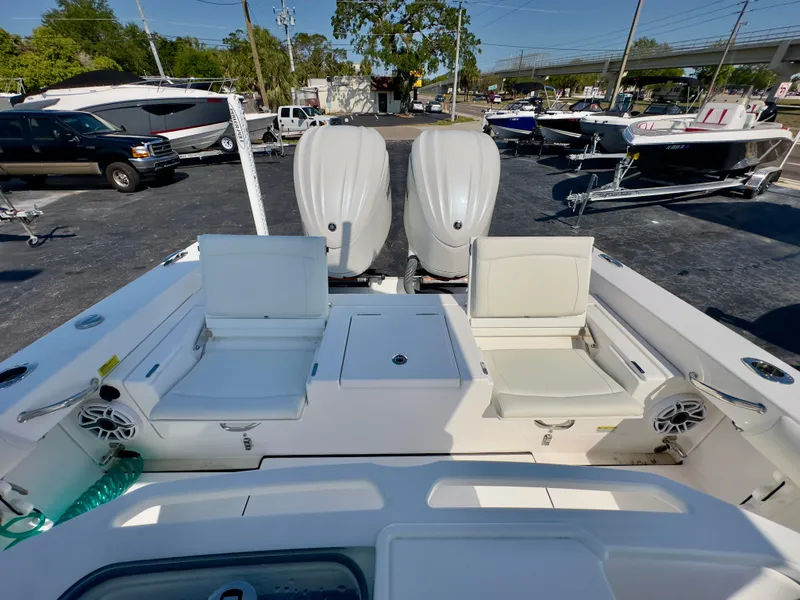 Slide: The Image of 2023 Everglades 273 Center Console boat with dual engines and seating, displayed outdoors. - 15