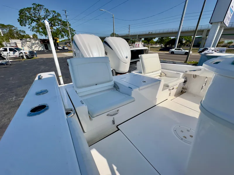 Slide: The Image of 2023 Everglades 273 Center Console boat with dual engines and seating area. - 16