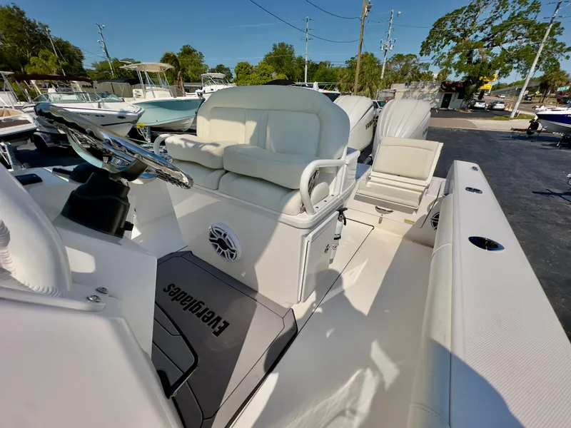 Slide: The Image of 2023 Everglades 273 Center Console boat with white seating and sleek design. - 19