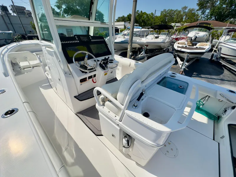Slide: The Image of 2023 Everglades 273 Center Console boat interior with helm and seating area. - 20