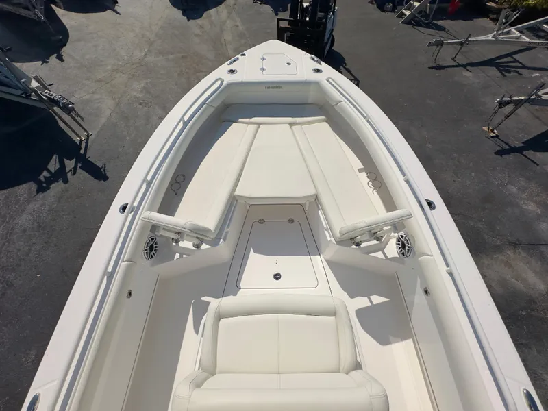 Slide: The Image of 2023 Everglades 273 Center Console boat interior with white seating and console. - 28