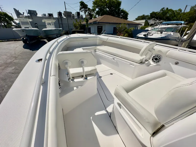 Slide: The Image of 2023 Everglades 273 Center Console boat interior with white seating and modern design. - 29
