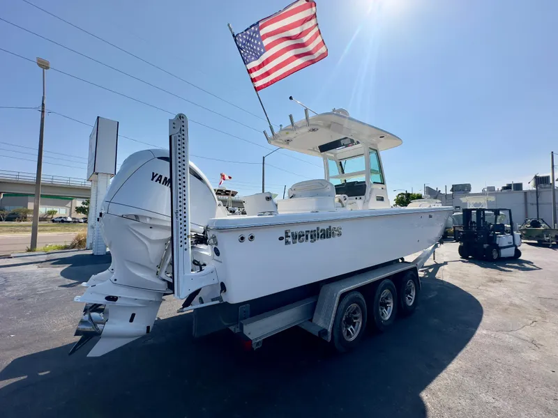 Slide: The Image of 2023 Everglades 273 Center Console boat on trailer, American flag, sunny day. - 3