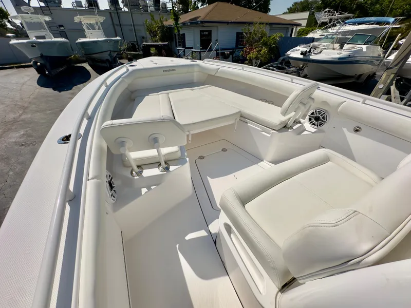 Slide: The Image of 2023 Everglades 273 Center Console boat interior with white seating and steering wheel. - 30