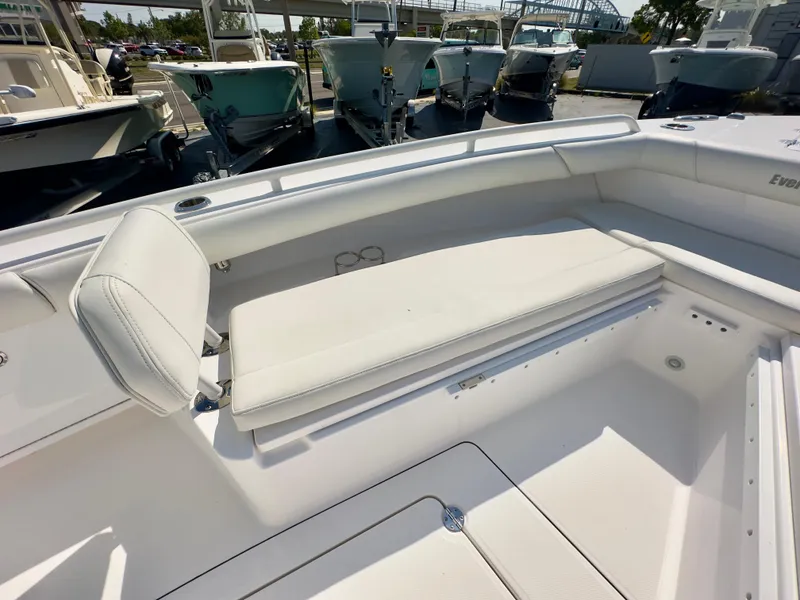 Slide: The Image of 2023 Everglades 273 Center Console boat with white seating in a marina setting. - 34
