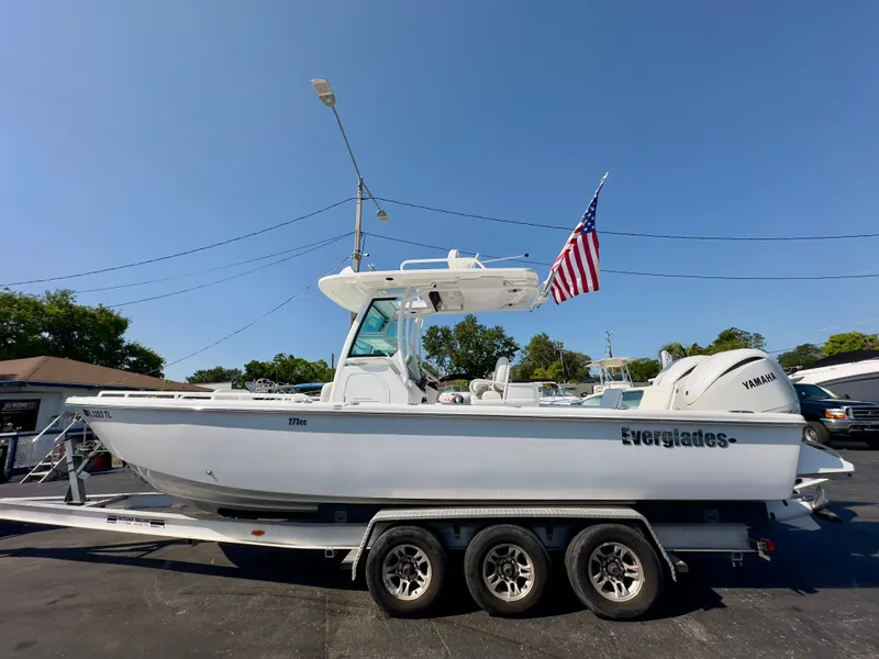 Slide: The Image of 2023 Everglades 273 Center Console boat on trailer with American flag, side view. - 6