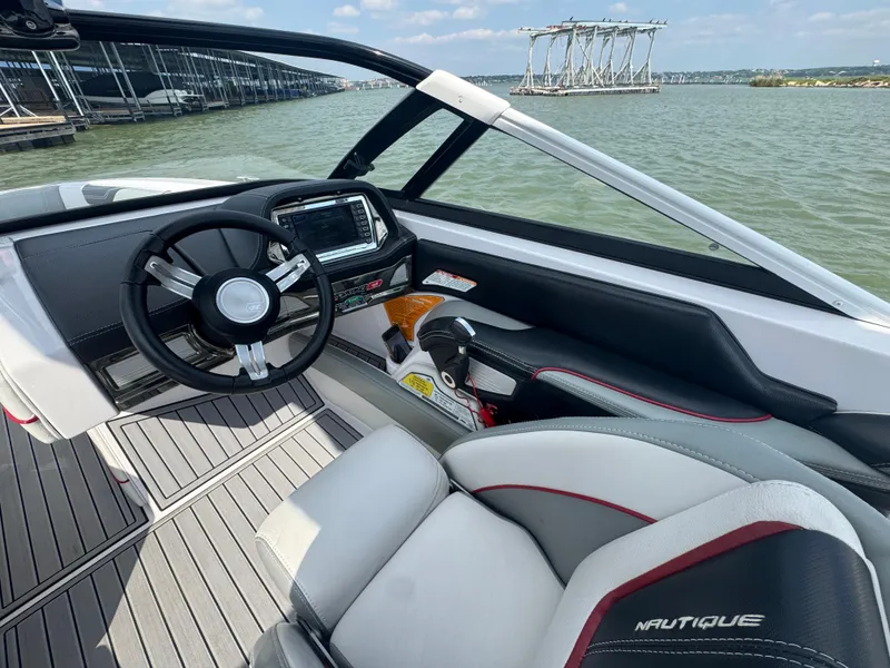 Slide: The Image of Interior of 2013 Nautique Super Air Nautique G25 boat with steering wheel and dashboard. - 10