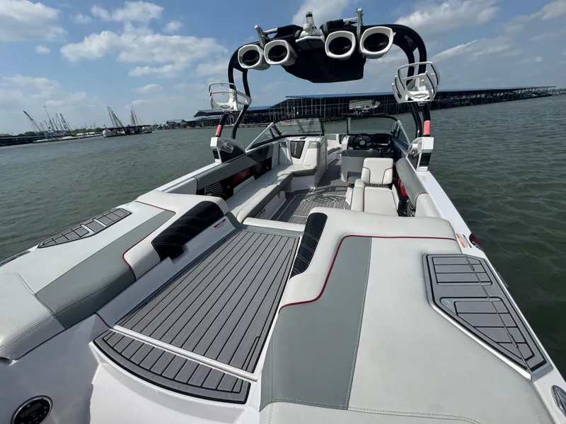 Slide: The Image of 2013 Nautique Super Air Nautique G25 boat interior with sleek seating and advanced sound system. - 14