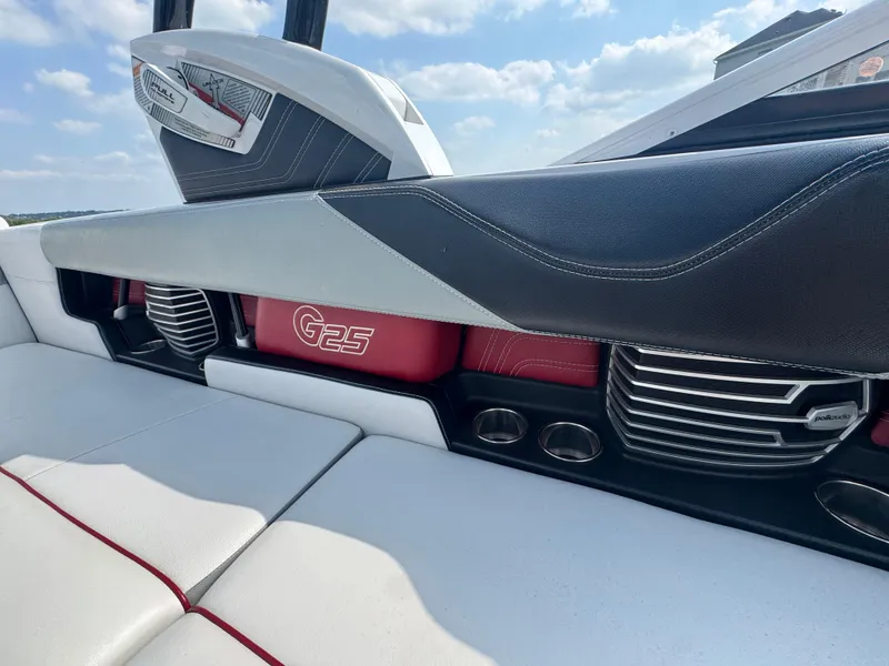 Slide: The Image of 2013 Nautique Super Air Nautique G25 interior with red and black accents, showcasing luxury design. - 15