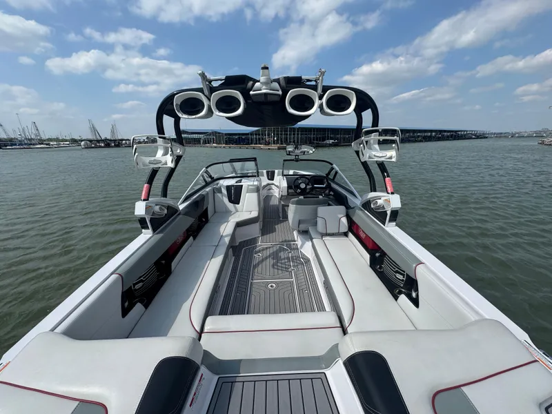 Slide: The Image of 2013 Nautique Super Air Nautique G25 boat interior with speakers, on a sunny day. - 16