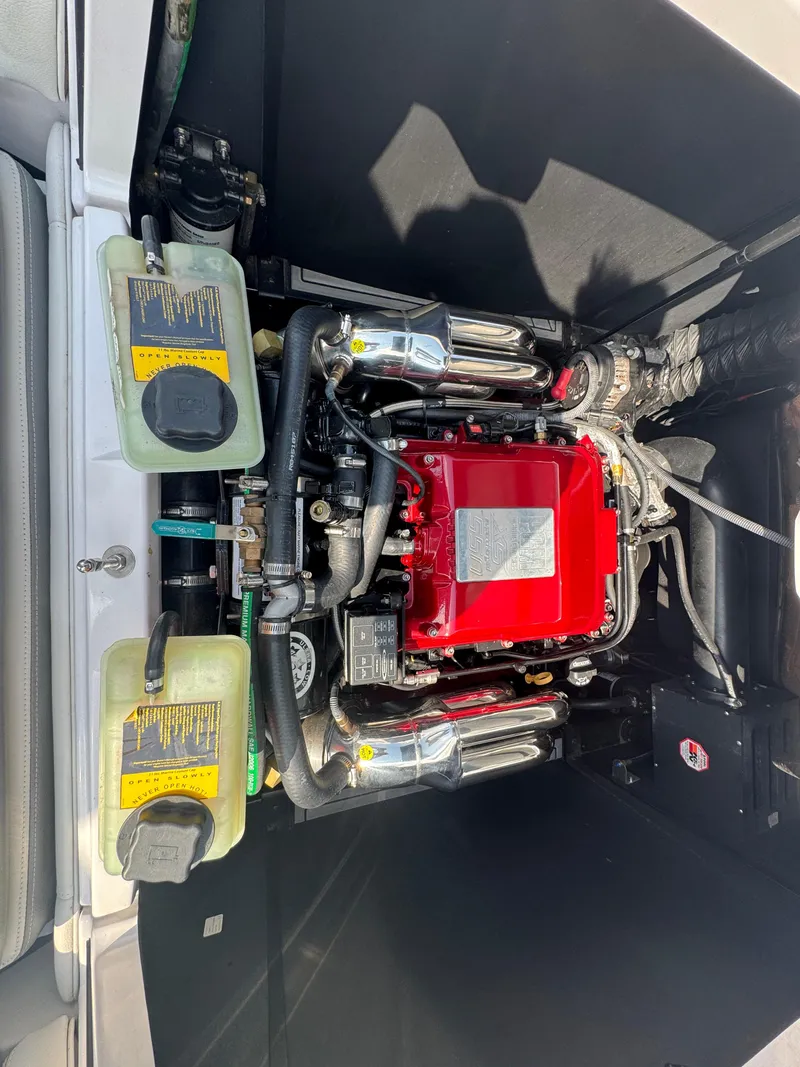 Slide: The Image of Engine compartment of 2013 Nautique Super Air Nautique G25 with red engine cover. - 18