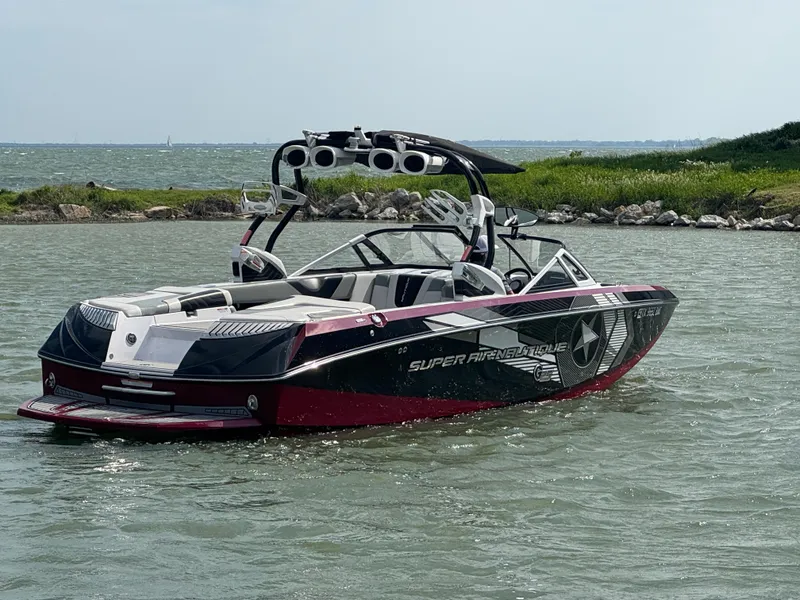Slide: The Image of 2013 Nautique Super Air Nautique G25 boat on water, featuring sleek design and vibrant colors. - 5