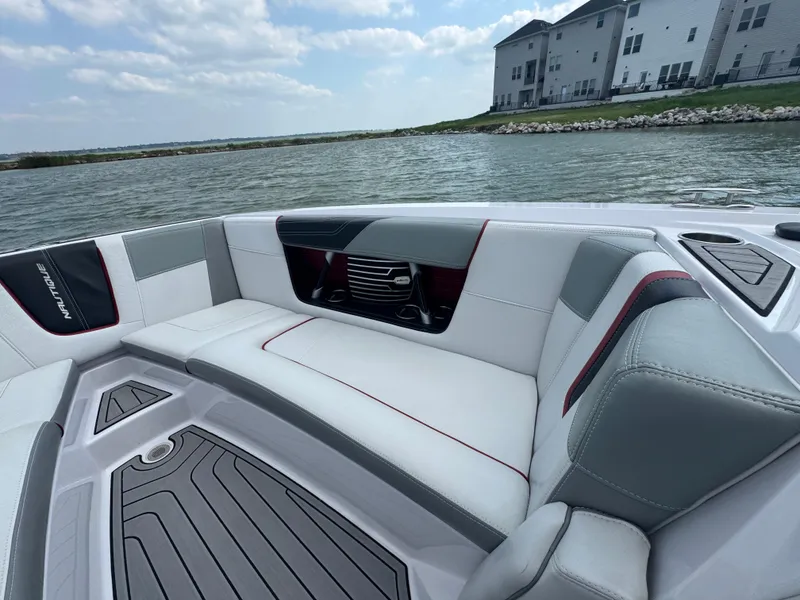 Slide: The Image of Luxurious interior of 2013 Nautique Super Air Nautique G25 boat on a serene lake. - 8