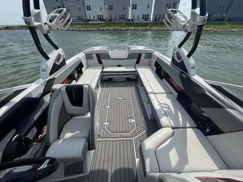 Slide: The Image of 2013 Nautique Super Air Nautique G25 interior with spacious seating and sleek design on the water. - 9