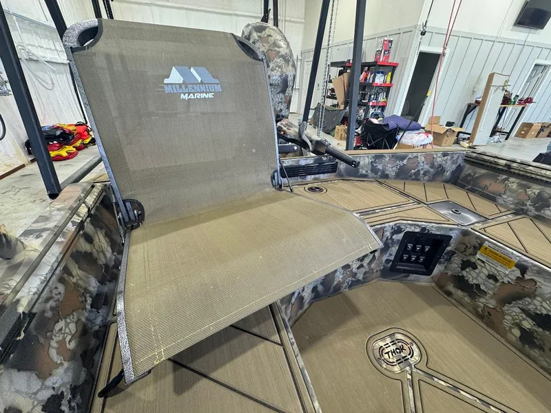 Slide: The Image of Boat interior with camo design, featuring a foldable seat and Thor TIMBER HAMMER branding, 2025 model. - 9