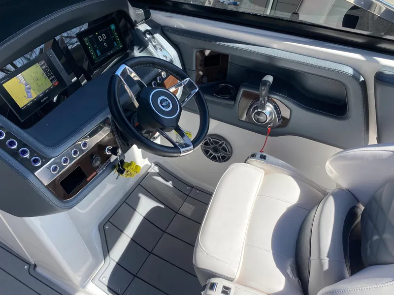 Slide: The Image of Interior cockpit of 2020 Chaparral 25 SURF boat with steering wheel and control panel. - 10