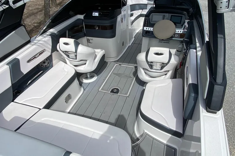Slide: The Image of 2020 Chaparral 25 SURF boat interior with modern seating and sleek design. - 11