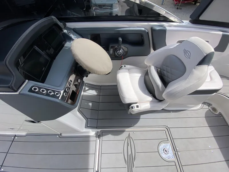 Slide: The Image of 2020 Chaparral 25 SURF boat cockpit with modern controls and comfortable seating. - 14