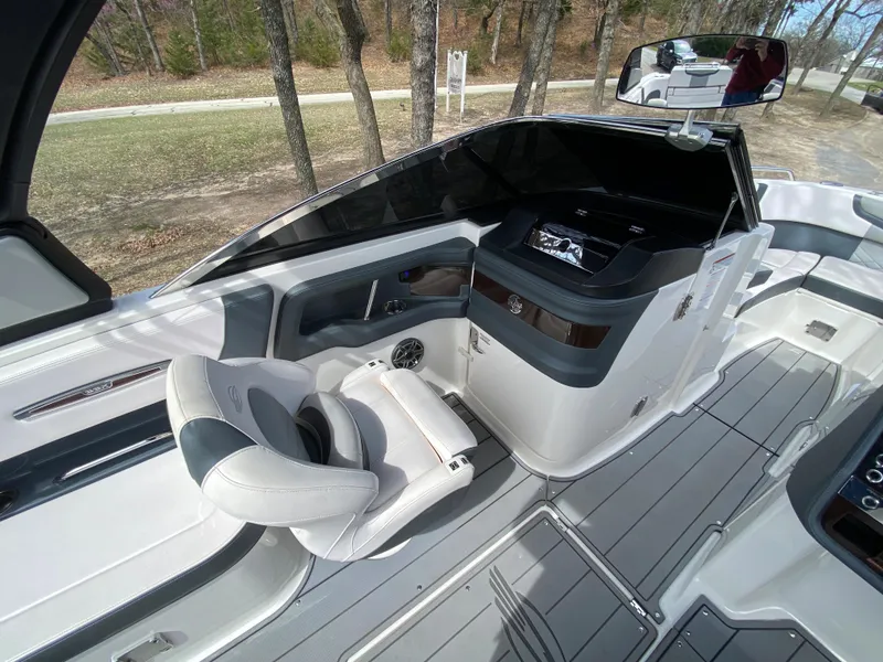 Slide: The Image of 2020 Chaparral 25 SURF boat interior with sleek seating and modern dashboard design. - 18