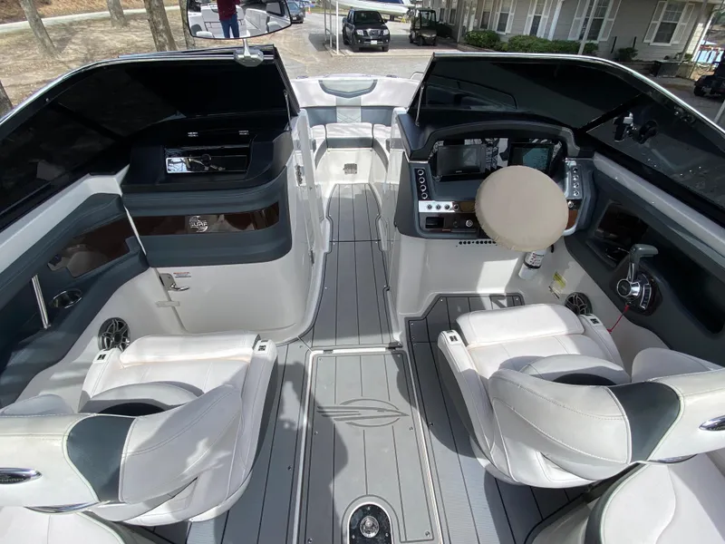 Slide: The Image of 2020 Chaparral 25 SURF boat interior with modern seating and control panel. - 19