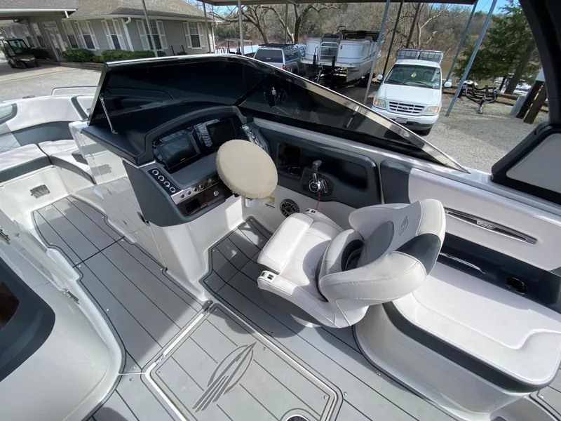 Slide: The Image of 2020 Chaparral 25 SURF boat interior with modern helm and seating. - 20