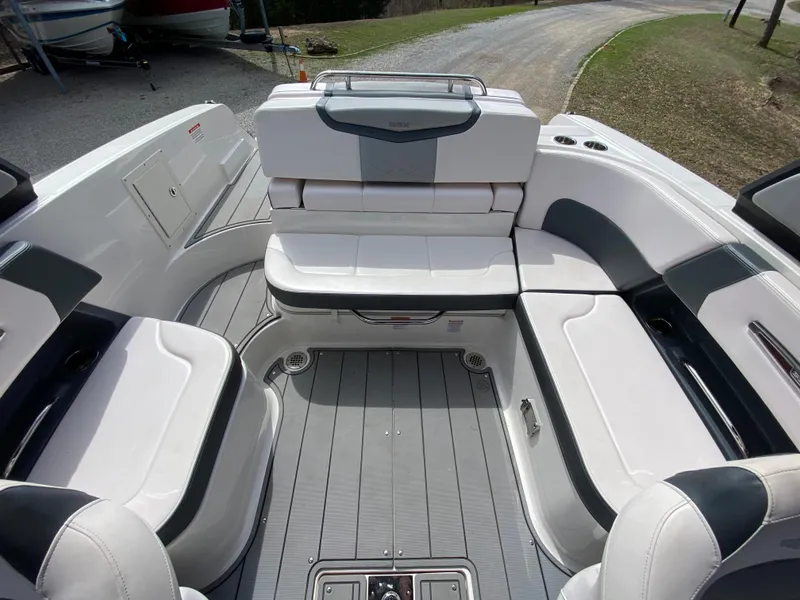 Slide: The Image of 2020 Chaparral 25 SURF boat interior with white and gray seating arrangement. - 26