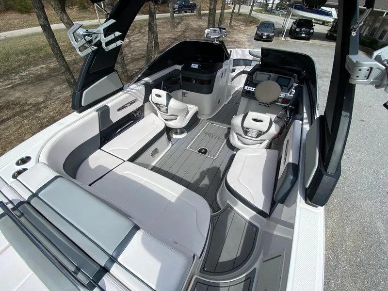 Slide: The Image of 2020 Chaparral 25 SURF boat interior with modern seating and sleek design. - 7
