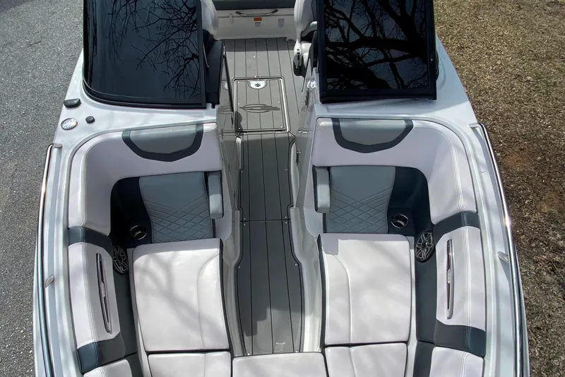 Slide: The Image of 2020 Chaparral 25 SURF boat interior with gray and white seating, sleek design. - 9