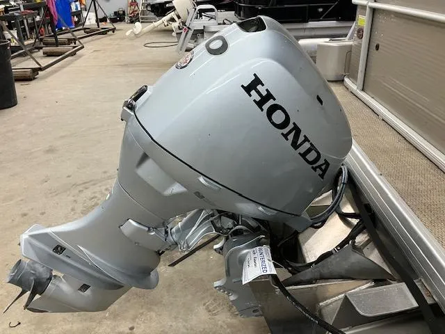 Slide: The Image of 2017 Godfrey Sweetwater 2286 C with Honda outboard motor in a workshop setting. - 11