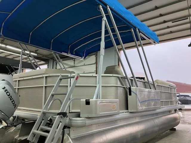 Slide: The Image of 2017 Godfrey Sweetwater 2286 C pontoon boat with blue canopy and Honda motor. - 5