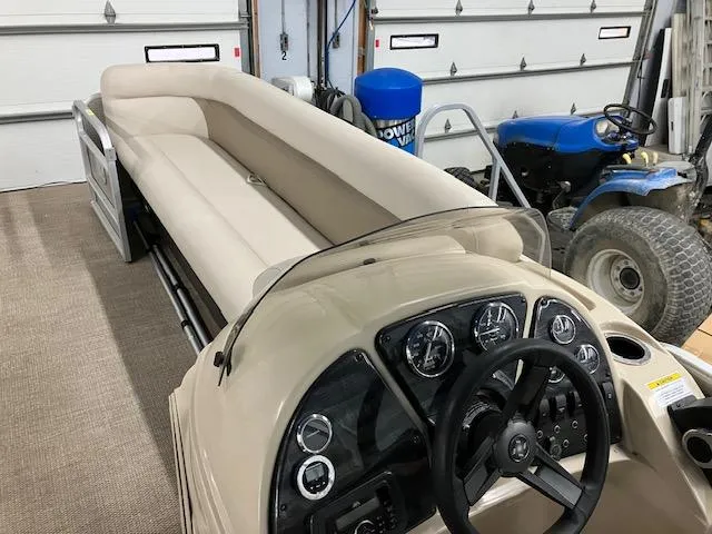 Slide: The Image of 2017 Godfrey Sweetwater 2286 C pontoon boat interior with beige seating and control panel. - 6
