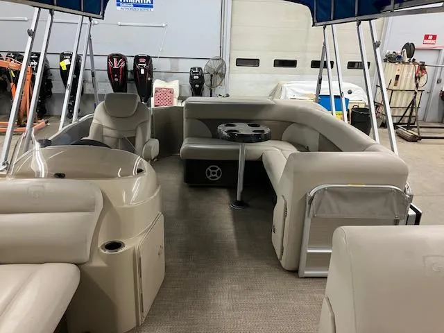 Slide: The Image of 2017 Godfrey Sweetwater 2286 C pontoon boat interior with beige seating and table. - 8