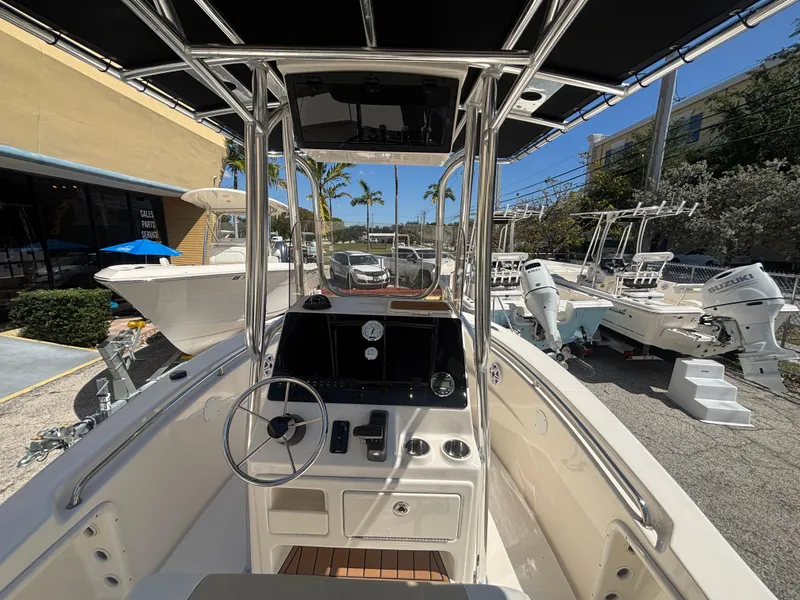 Slide: The Image of 2025 Bulls Bay 200 Center Console boat interior with steering wheel and controls. - 12