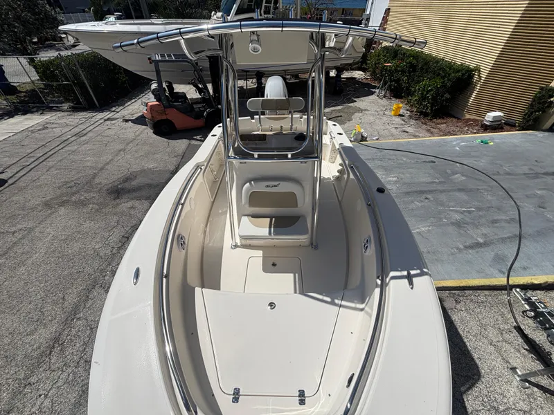 Slide: The Image of 2025 Bulls Bay 200 Center Console boat, sleek design, parked outdoors. - 7