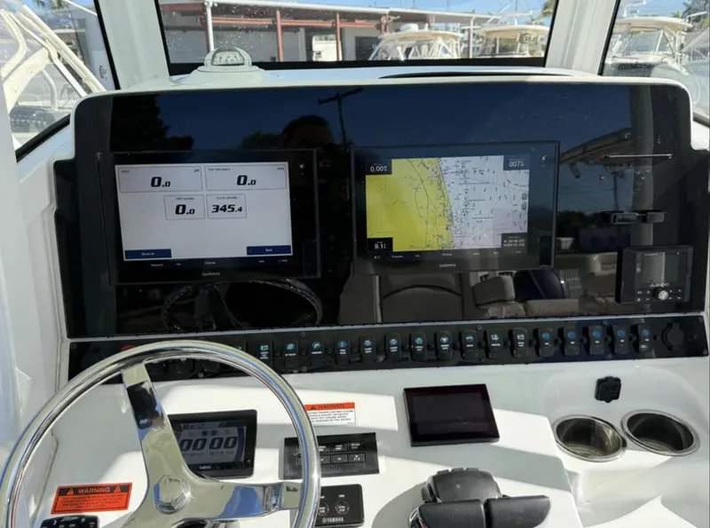 Slide: The Image of 2021 Sea Hunt Gamefish 30 dashboard with navigation screens and controls. - 11