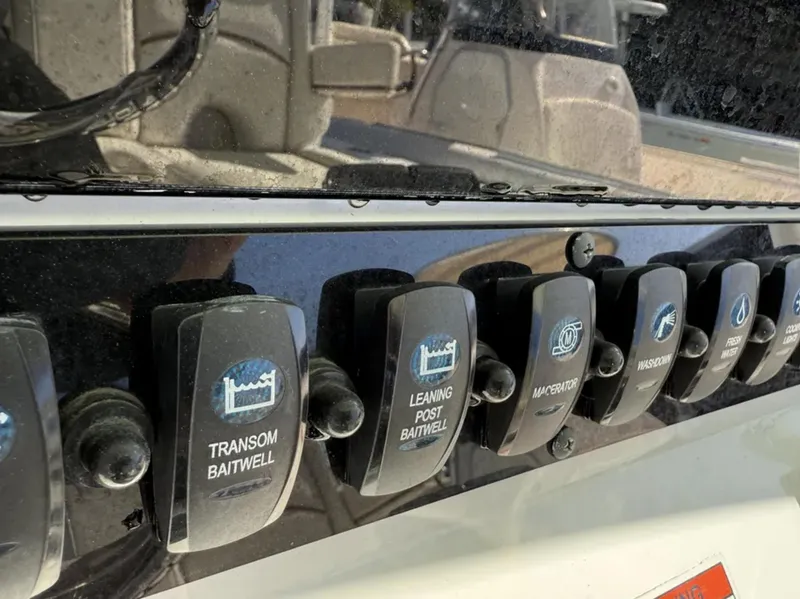 Slide: The Image of Control panel on 2021 Sea Hunt Gamefish 30, featuring baitwell and accessory switches. - 13