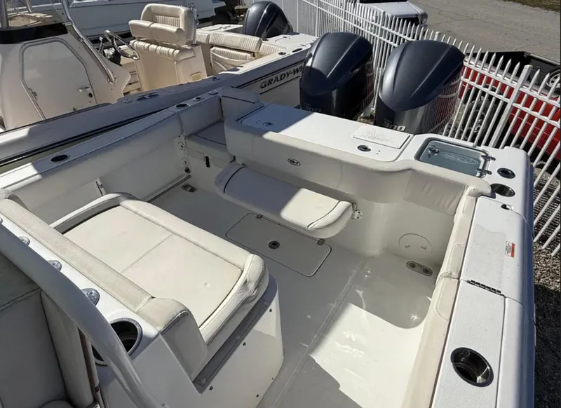 Slide: The Image of 2021 Sea Hunt Gamefish 30 Forward Seating boat interior with white cushioned seats and dual engines. - 14