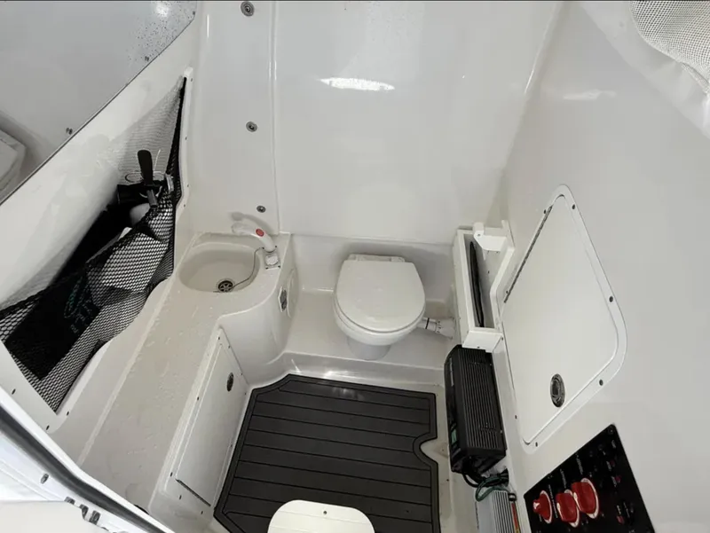 Slide: The Image of 2021 Sea Hunt Gamefish 30 boat interior with toilet and sink, featuring modern amenities. - 16