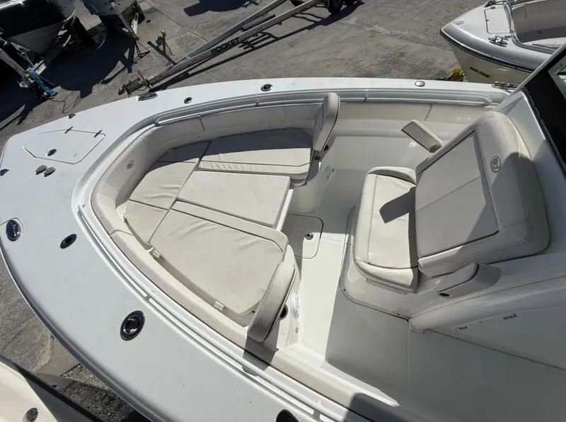 Slide: The Image of 2021 Sea Hunt Gamefish 30 Forward Seating, white cushioned bow area, outdoor setting. - 18