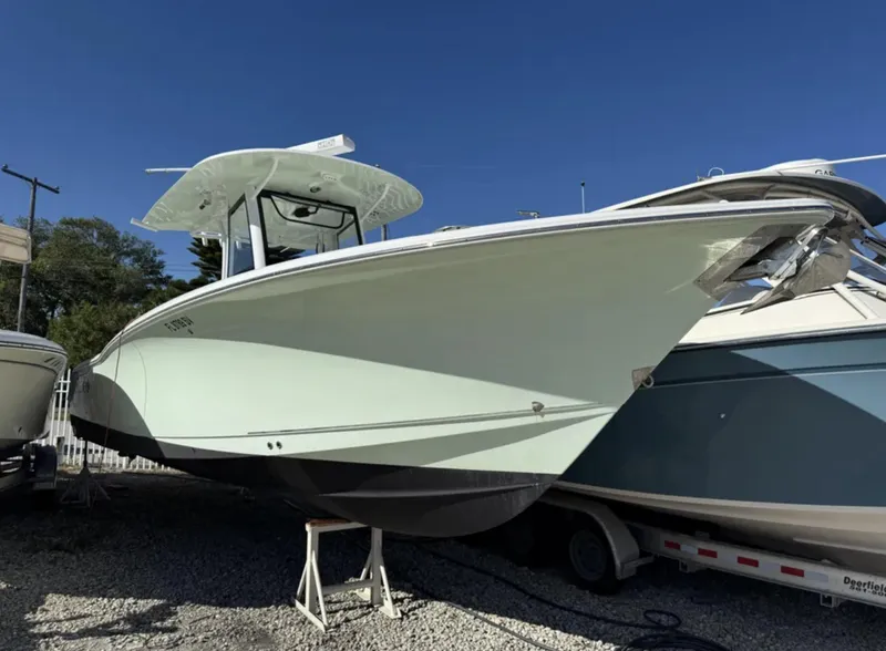 Slide: The Image of 2021 Sea Hunt Gamefish 30 Forward Seating boat on display outdoors. - 2