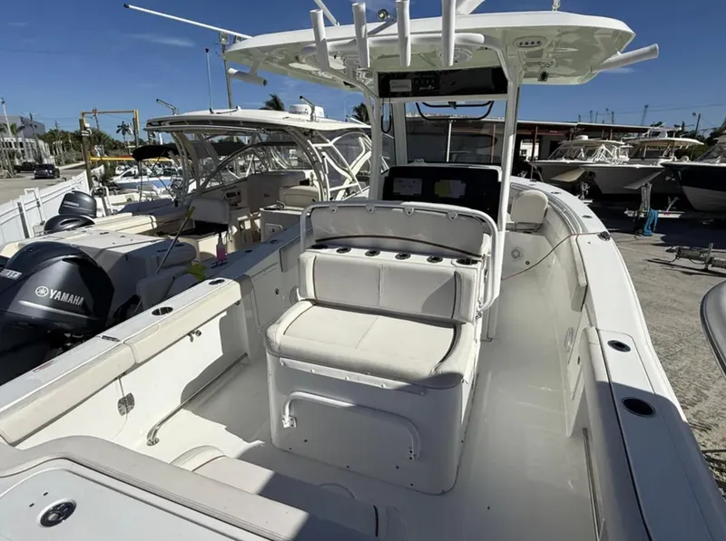 Slide: The Image of 2021 Sea Hunt Gamefish 30 Forward Seating boat with Yamaha engines, docked in a marina. - 29