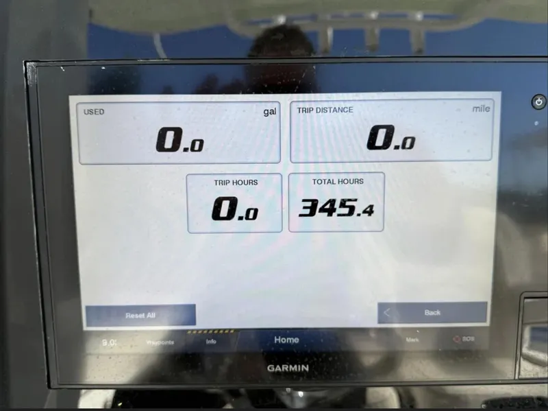 Slide: The Image of Garmin display on 2021 Sea Hunt Gamefish 30, showing trip and total hours. - 30