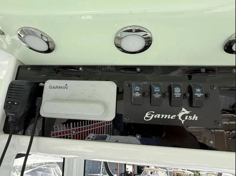 Slide: The Image of Control panel of 2021 Sea Hunt Gamefish 30 with Garmin device and switches. - 31