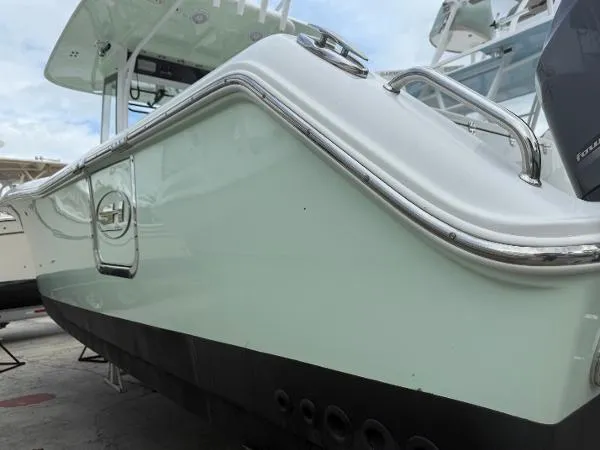 Slide: The Image of 2021 Sea Hunt Gamefish 30 Forward Seating boat, side view with sleek design and chrome detailing. - 35