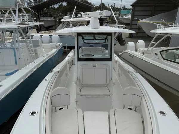 Slide: The Image of 2021 Sea Hunt Gamefish 30 Forward Seating boat in marina, showcasing sleek design and spacious layout. - 40
