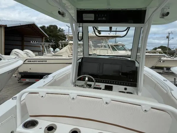 Slide: The Image of 2021 Sea Hunt Gamefish 30 Forward Seating boat interior with control panel and steering wheel. - 43