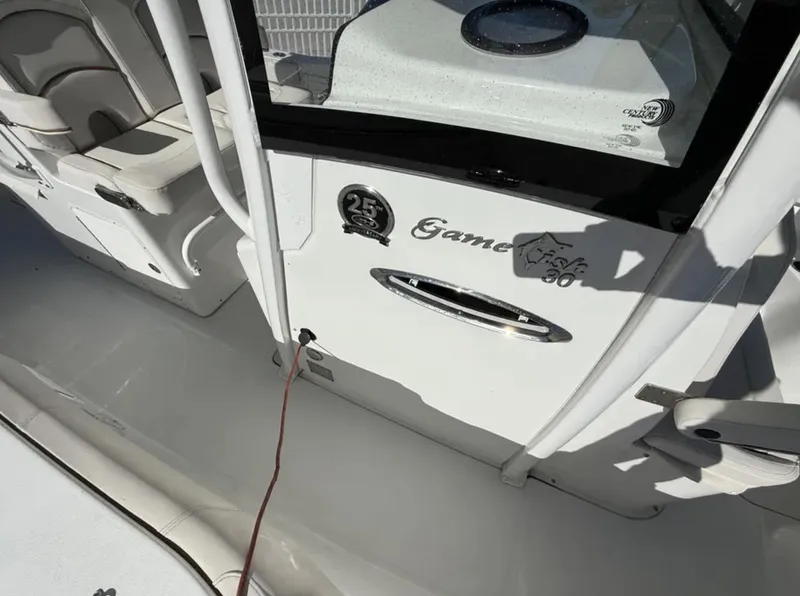 Slide: The Image of 2021 Sea Hunt Gamefish 30 Forward Seating boat interior, featuring sleek design and seating area. - 6