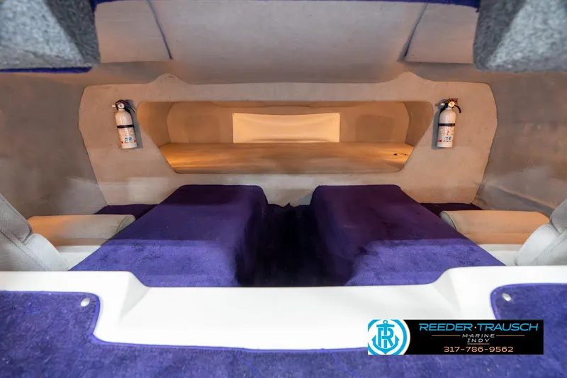 Slide: The Image of 2001 Eliminator 26 Daytona interior with purple upholstery and fire extinguishers. - 17